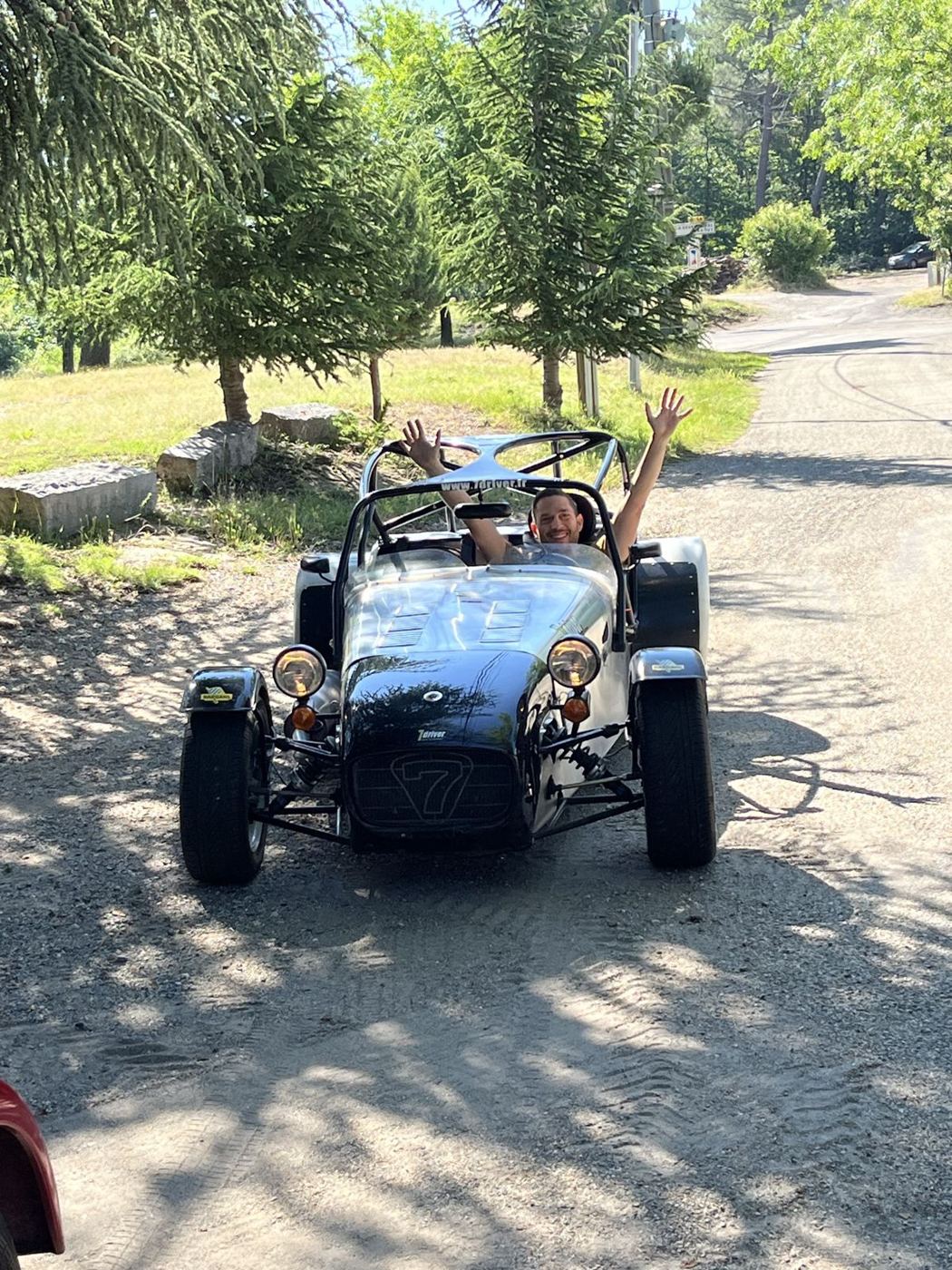 Équipage heureux au volant d'une Caterham